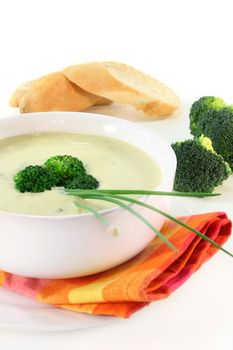 a cup of broccoli cream soup with fresh vegetables