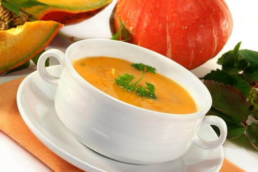 a white Soup cup with fresh pumpkin soup