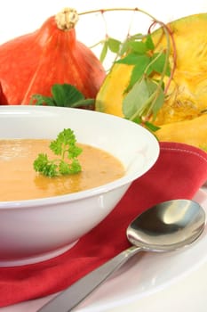 a white plate with fresh pumpkin soup