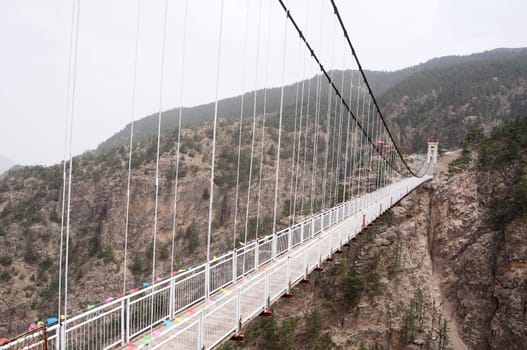 Landscape of a long drawbridge over the valley