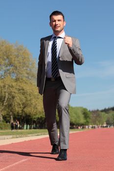businessman on a running track in spring