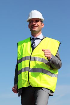young businessman with hardhat and yellow vest