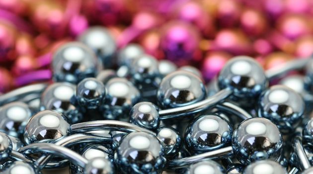 A bulk pile of titanium anodized navel belly rings