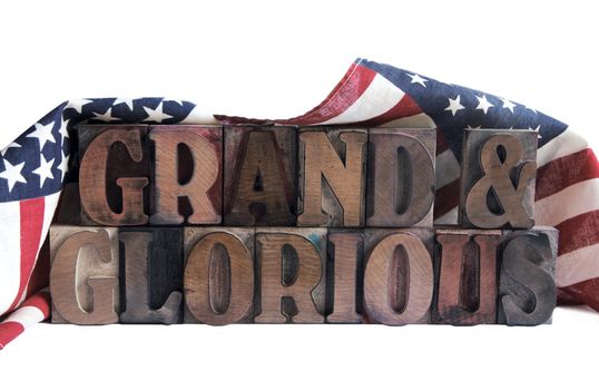 the words 'grand & glorious' draped with American flags

