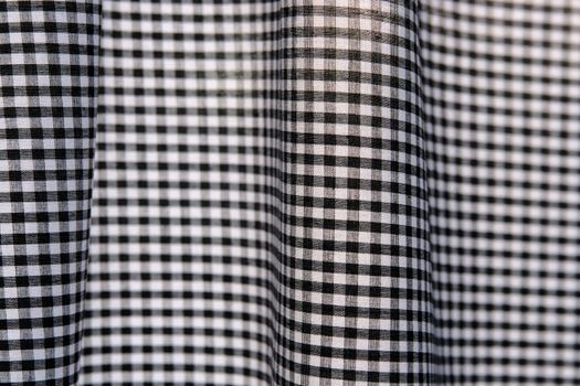 black and white gingham checks that give an op art or psychedelic effect