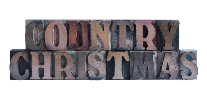 the words 'country Christmas' in old, ink-stained wood type
