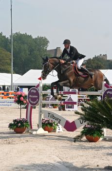 THE HAGUE, HOLLAND - AUGUST 31, 2008: Concours Hippique. Horse clearing a hurdle at the annual horse jumping competition at Westbroek Park.