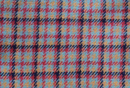 background of vintage wool multicolored plaid fabric