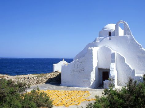 Church and fishing nets drying on the greek island of Paros