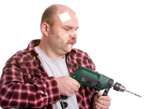 Mature man trying to drill something covered in bandaids