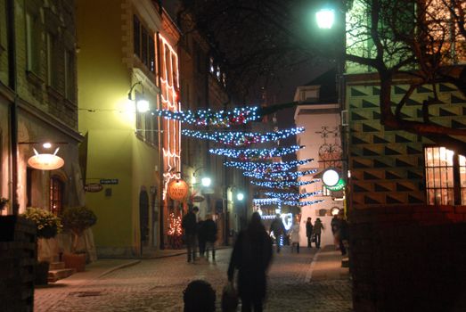 Night view of one of Warsaw old town streets in the night. Christmas decorations.