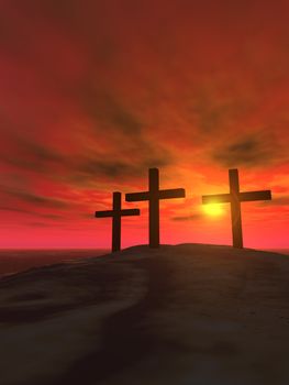 Three crosses on a hill on a background of a sunset