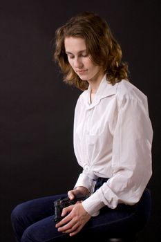 woman on black handing gun
