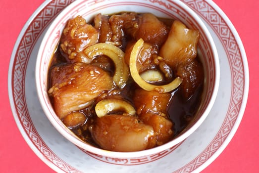 Chinese bowl with chicken in marinade.              