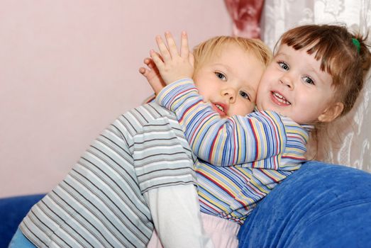The boy in embraces of the girl. Children age 2 years
