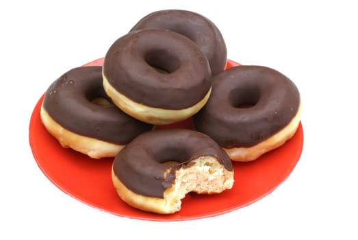 Chocolate donuts on a red dish.          