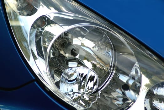 Headlight of a blue car.