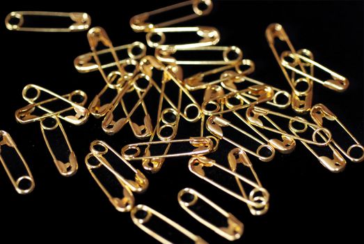 A pile of gold coloured paper clips