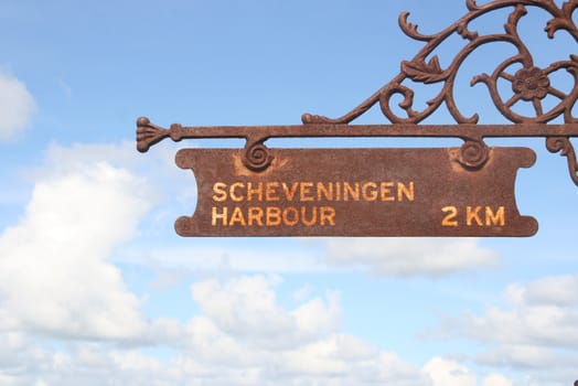 Rusty sign at the Dutch beach resort of Scheveningen saying Scheveningen Harbour