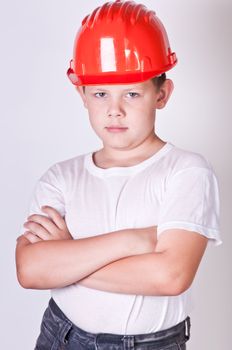 Portrait of a boy in a red protective helmet