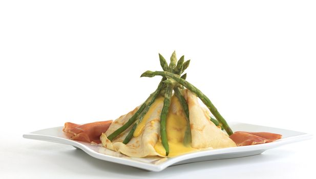 Green asparagus and pancake tipi with Hollandaise sauce on top and ham on the sides (Selective Focus, Focus on top)