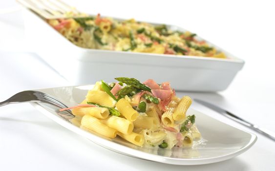 Green asparagus, ham and pasta casserole (Selective Focus, Focus on the front of the food on the plate)