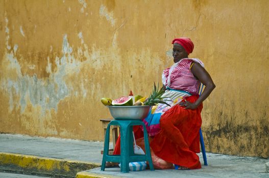 CARTAGENA DE INDIAS , COLOMBIA - DEC 21:Unidentified Palenquera woman sell fruts in Cartagena de Indias on December 21 2010,Palenqueras are  a unique African descendat ethnic group found in the north region of South America