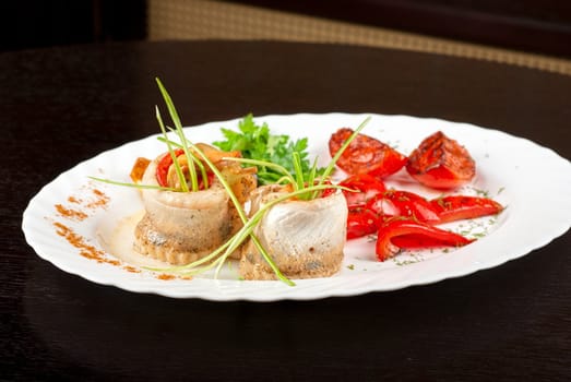 fillet of pikeperch stuffed with trout fish with baked pepper, tomato and leek