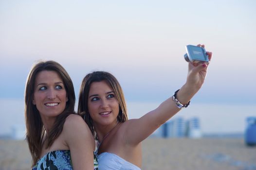 Two girls on the beach taking a self portrait
