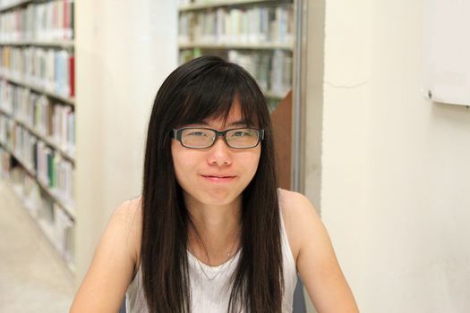 Asian girl student in library