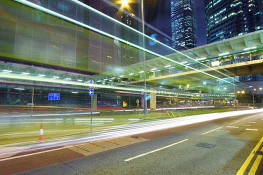 Traffic through downtown of Hong Kong at night in rainy day