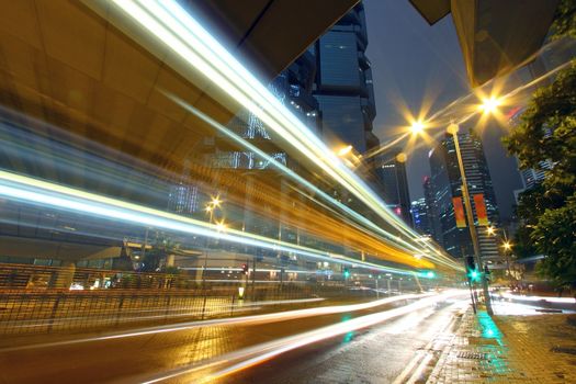 Traffic through downtown of Hong Kong at night in rainy day