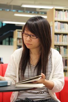 Asian girl student in library