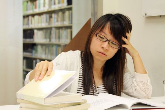 Asian girl student in library