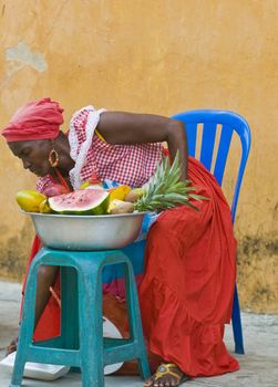 CARTAGENA DE INDIAS , COLOMBIA - DEC 21:Unidentified Palenquera woman sell fruts in Cartagena de Indias on December 21 2010,Palenqueras are  a unique African descendat ethnic group found in the north region of South America