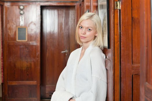Portrait of attractive young blond woman in a bathrobe