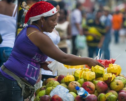 CARTAGENA DE INDIAS , COLOMBIA - DEC 21:Unidentified colombian woman sell fruits in the street of Cartagena de Indias on December 21 2010