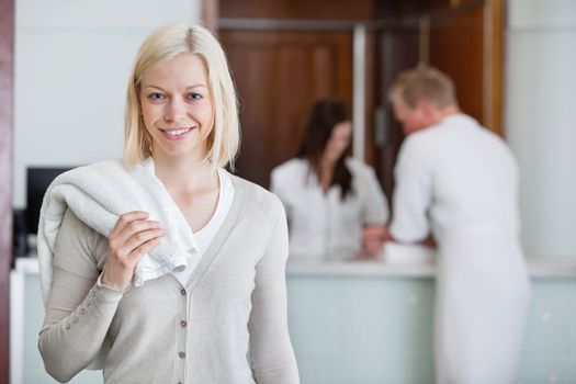 Pretty Caucasian woman with people in background at spa centre