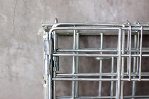 A metal lattice near a concrete wall
