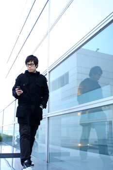 Business man using cellphone when waiting in station. 