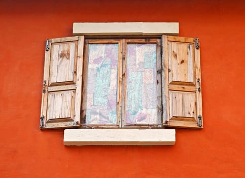 Vintage window on orange cement wall