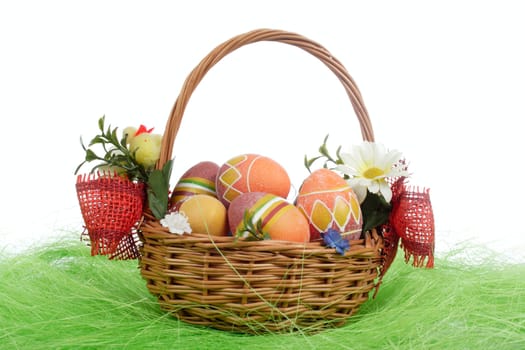 Easter eggs in basket on green Grass