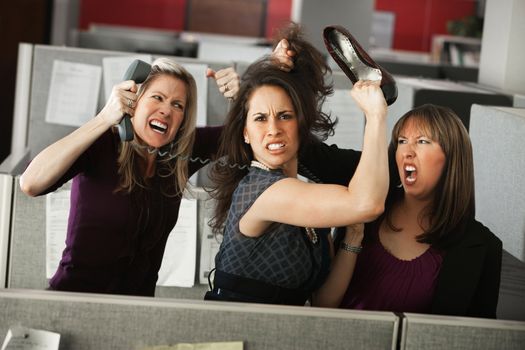 Three women office workers quarreling in cubicle 