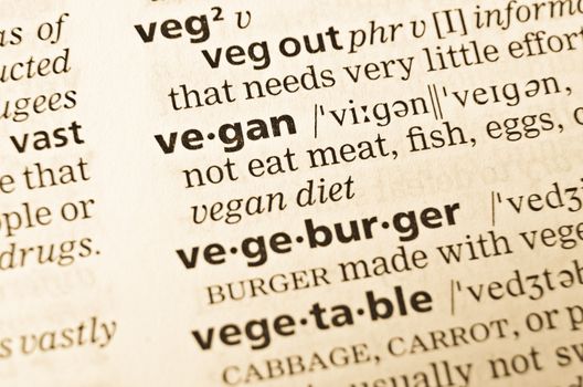 The word vegan in the old dictionary. Selective focus effect.