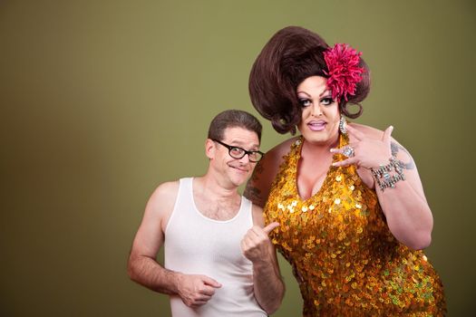 Caucasian man with drag queen on green background