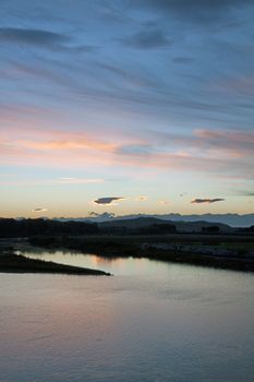A landscape of the river under sunset sky