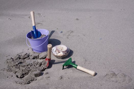 Toy-buckets in the sand on the beach 