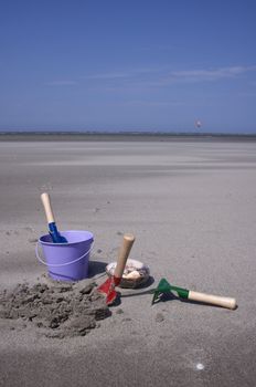 Toy-buckets in the sand on the beach 