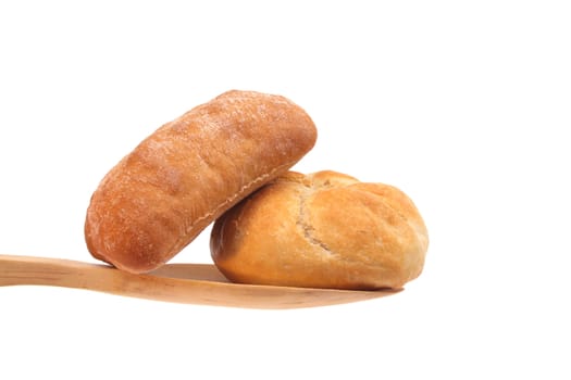 Two buns on a wooden spoon against a white background
