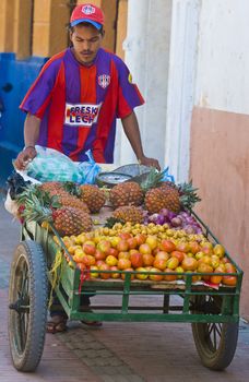 CARTAGENA DE INDIAS , COLOMBIA - DEC 20:Unidentified colombian man sell fruits in the street in Cartagena de Indias on December 20 2010